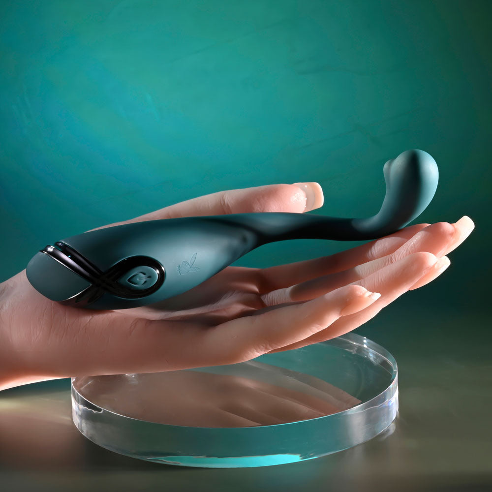 Playboy Pleasure PINPOINT PERFECTION - 19.3 cm USB Rechargeable Poseable Vibrator held in a hand.