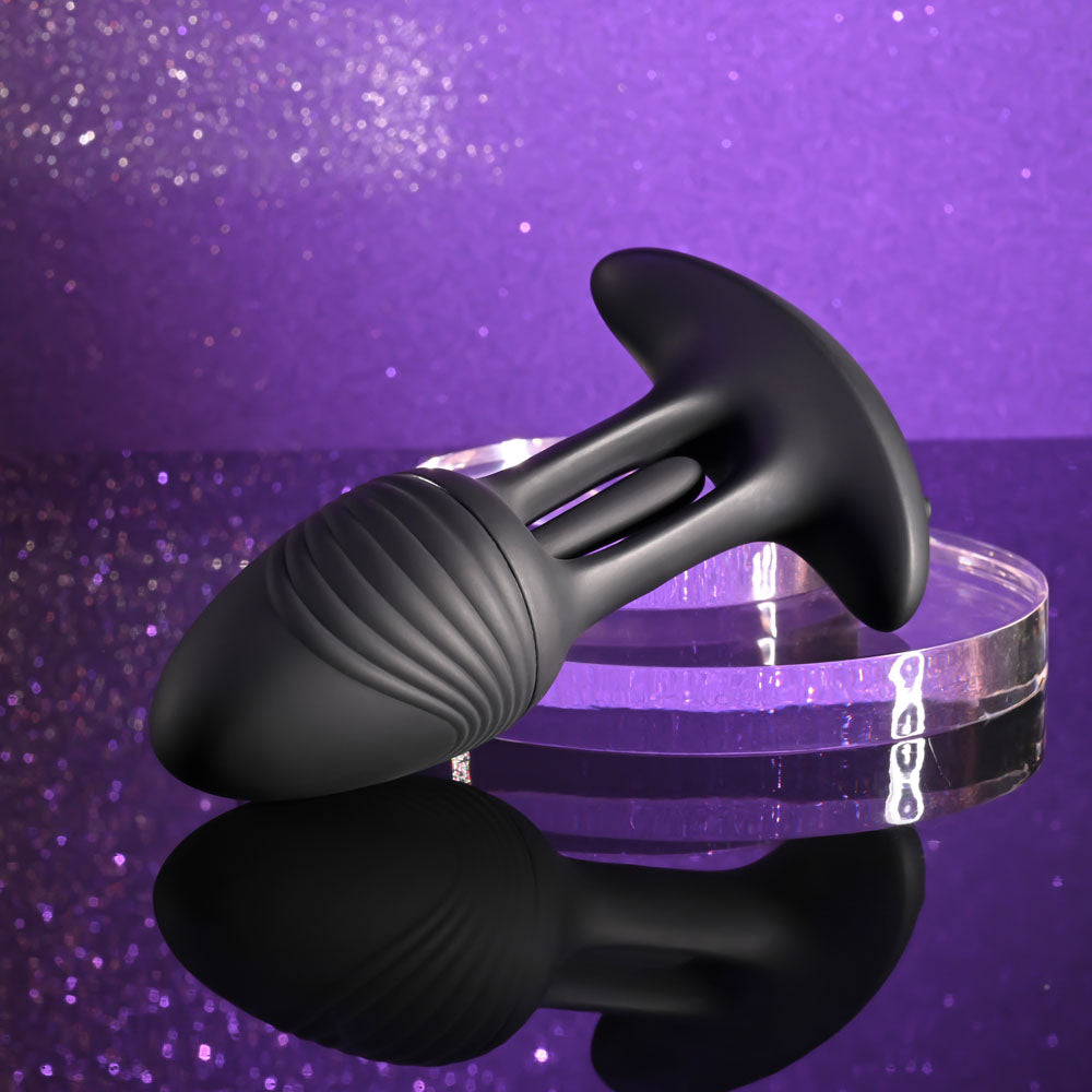 Playboy Pleasure RIM SHOT -  11.4 cm USB Rechargeable Vibrating Butt Plug on a reflective surface with a sparkle background.