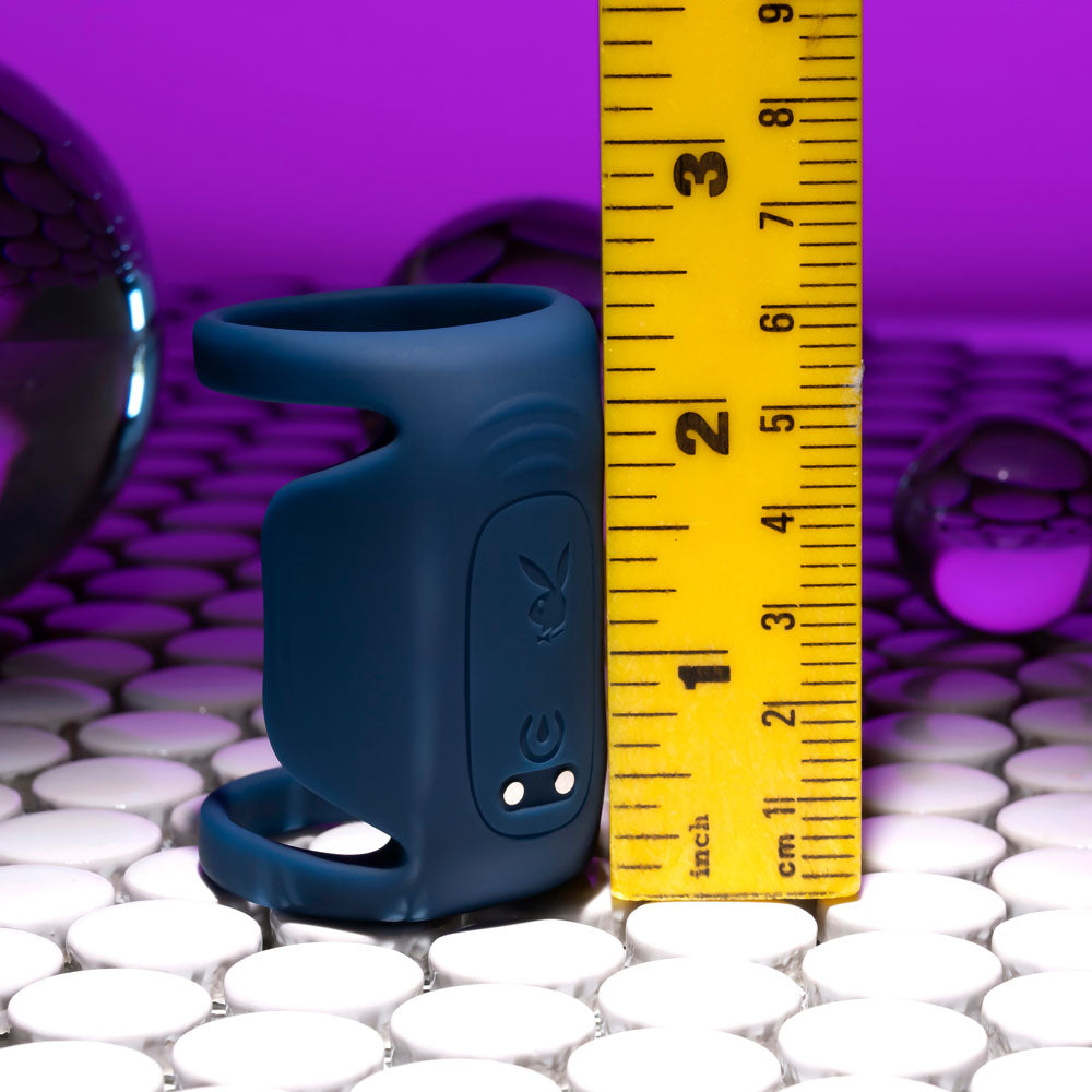 Playboy Pleasure JET PACK - Dark USB Rechargeable Vibrating Penis Harness next to a ruler for size reference.