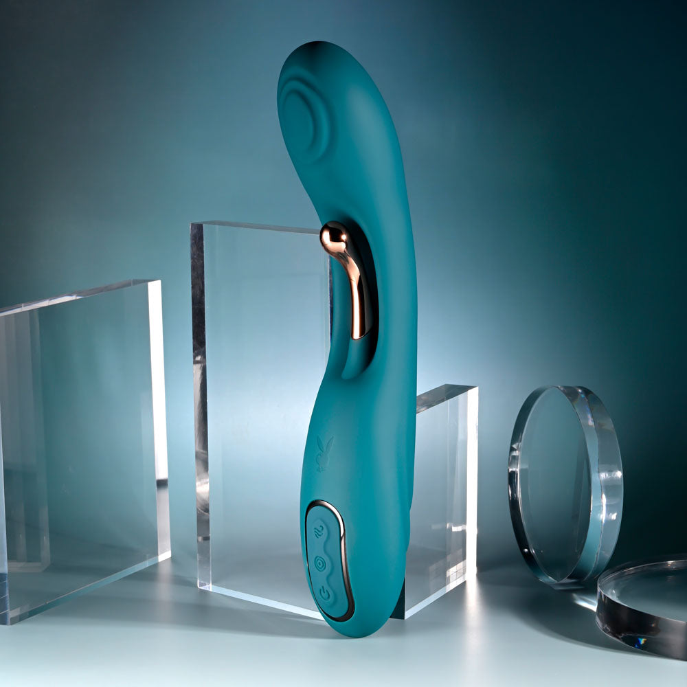 Playboy Pleasure AURELIE - 22.7 cm USB Rechargeable Vibrator with Internal Flicker showcased among crystal displays.