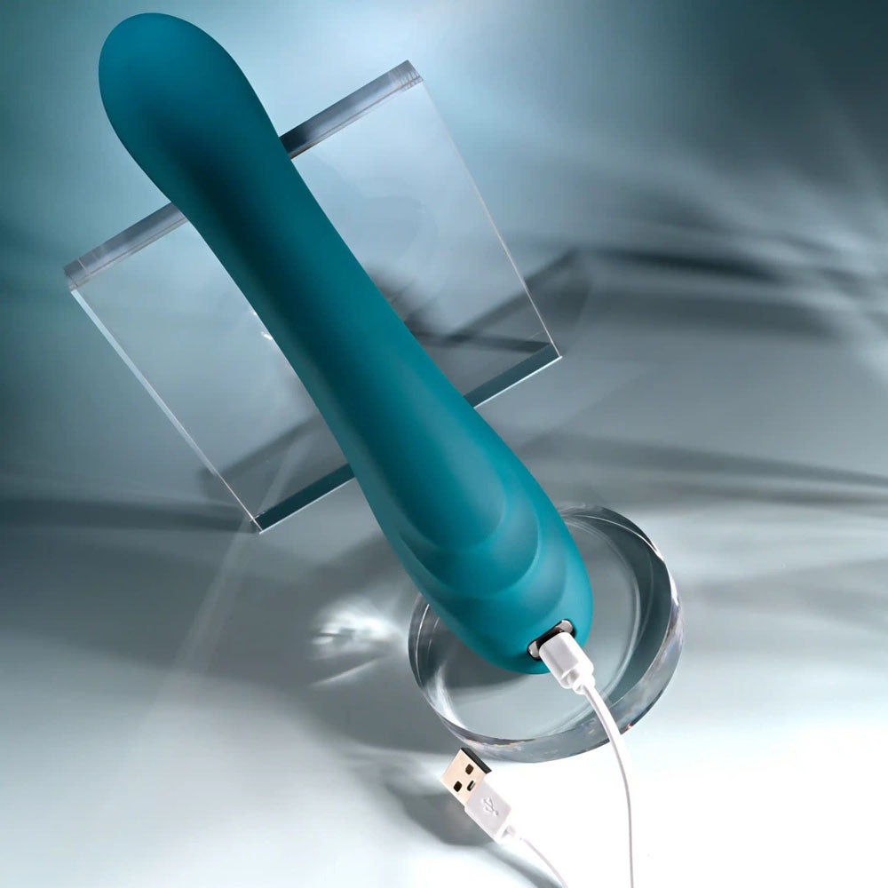 Playboy Pleasure AURELIE -  22.7 cm USB Rechargeable Vibrator with Internal Flicker on display with charging cable.