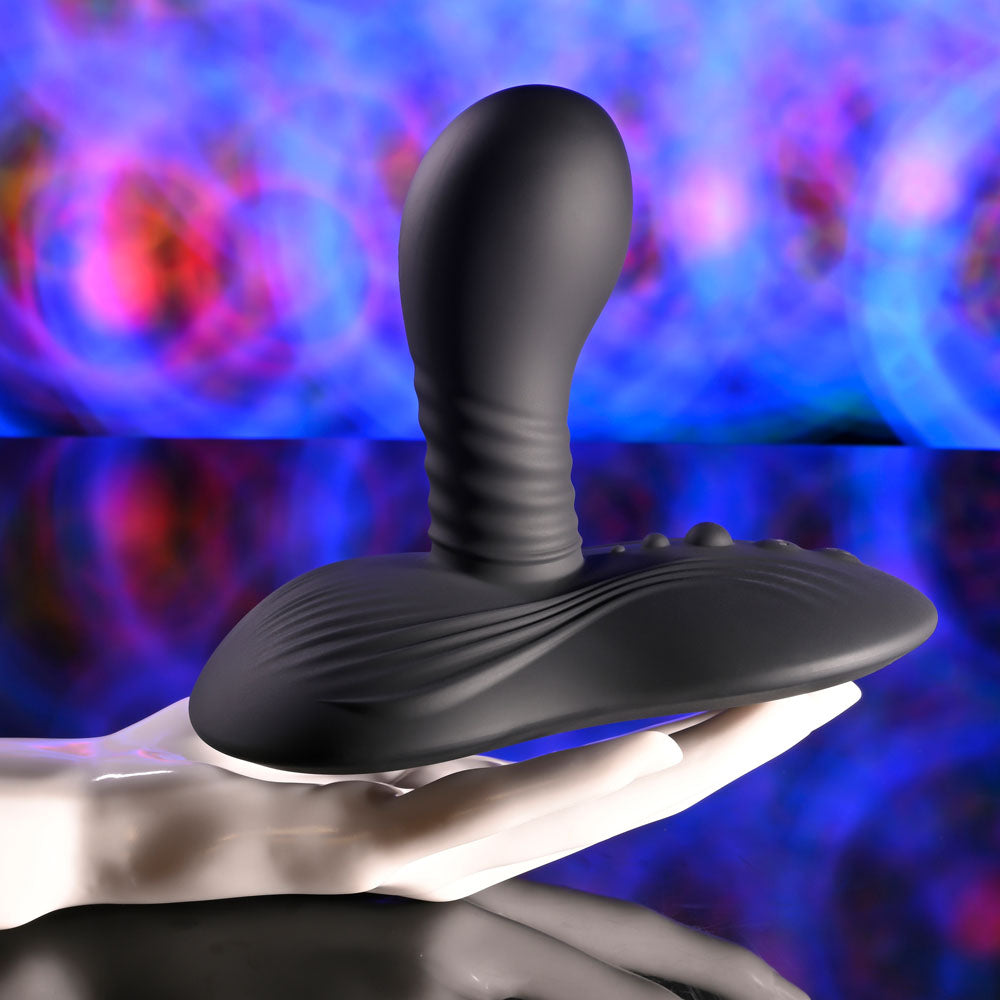 Playboy Pleasure SITTIN & SPINNIN - USB Rechargeable Spinning Vibrator & Grinder Pad with Remote on a hand.