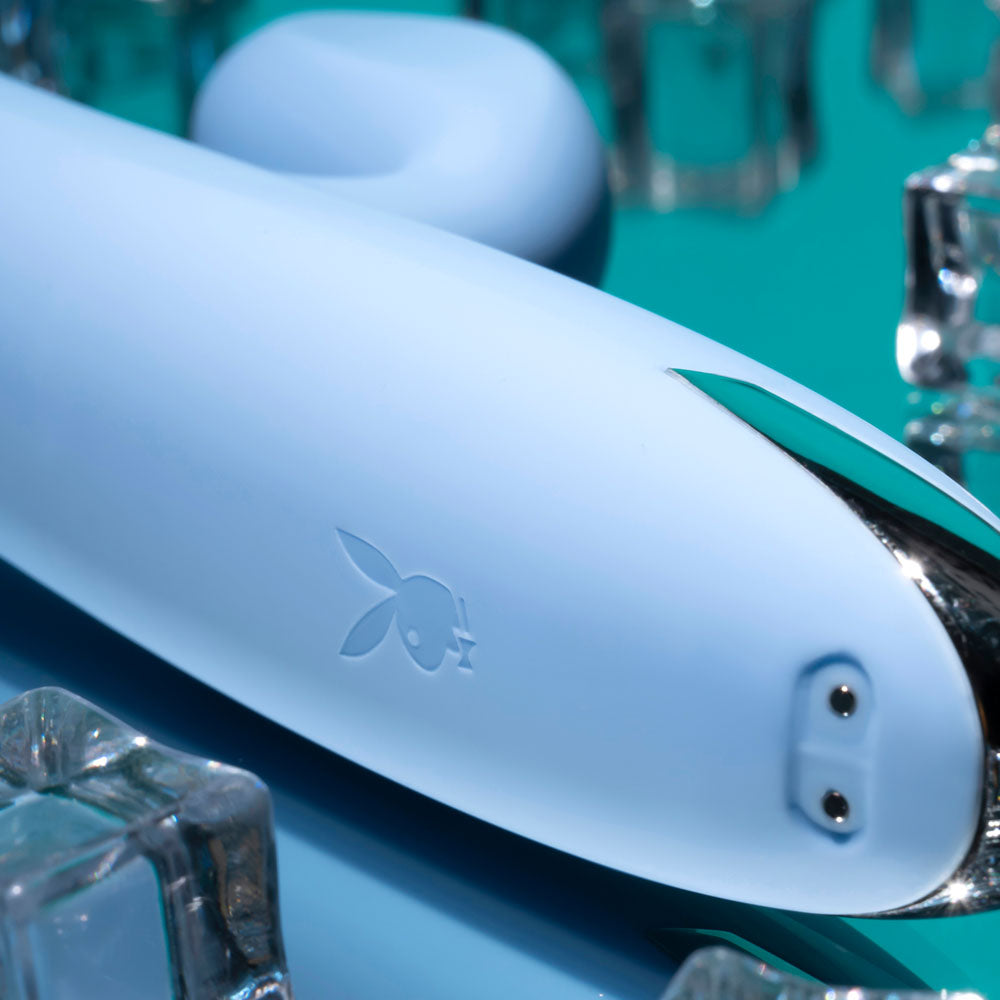 Playboy Pleasure UP AND AWAY - 26.7 cm USB Rechargeable Rabbit Vibrator on a teal background with ice cubes.