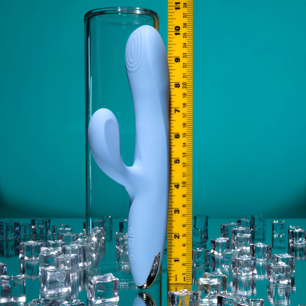 Playboy Pleasure UP AND AWAY - 26.7 cm USB Rechargeable Rabbit Vibrator next to a tape measure on a reflective surface.