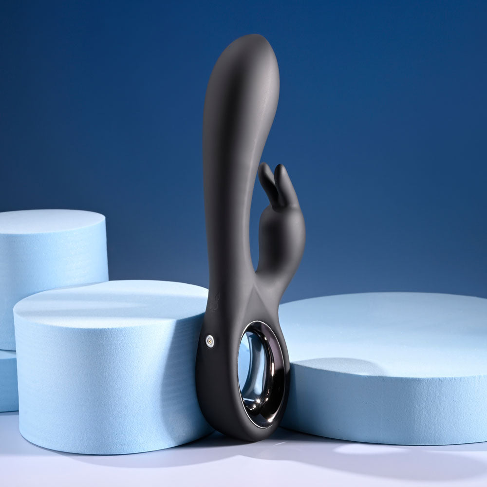 USB rechargeable rabbit vibrator on display with soft blue foam backgrounds, highlighting its sleek design and cherry chrome handle.