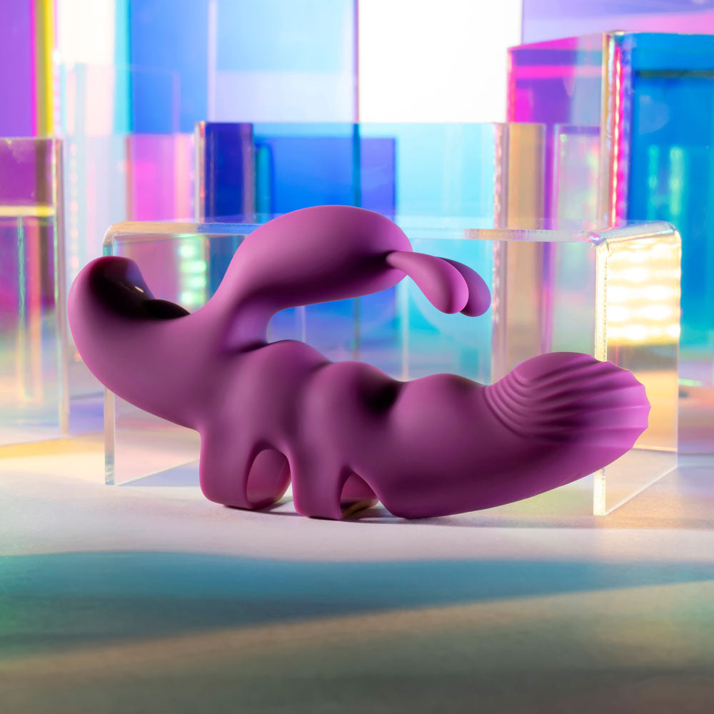 Playboy Pleasure LEND A HAND -  USB Rechargeable Finger Vibrator displayed on colorful background.