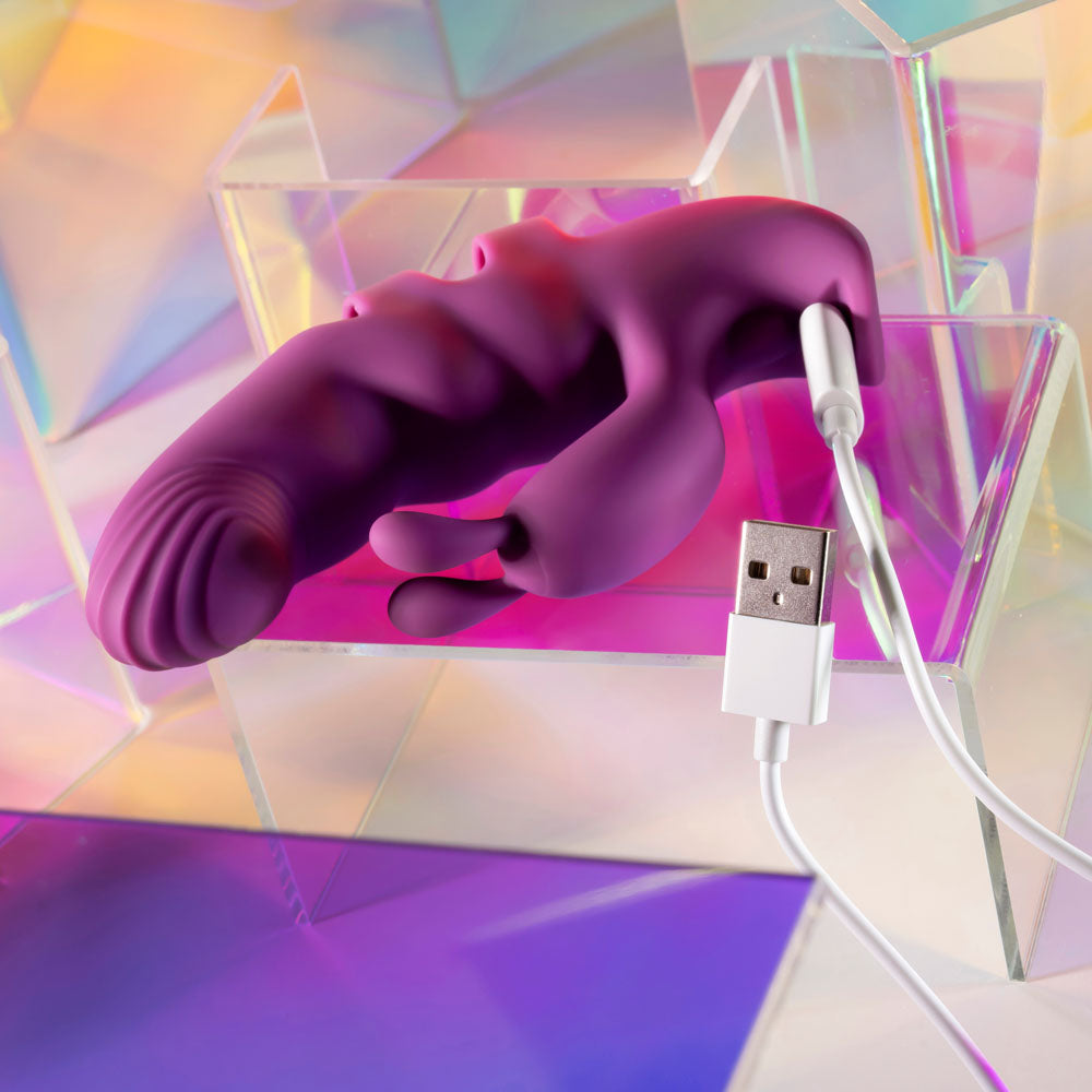 Playboy Pleasure LEND A HAND - USB Rechargeable Finger Vibrator in vibrant colors with USB cable for charging.