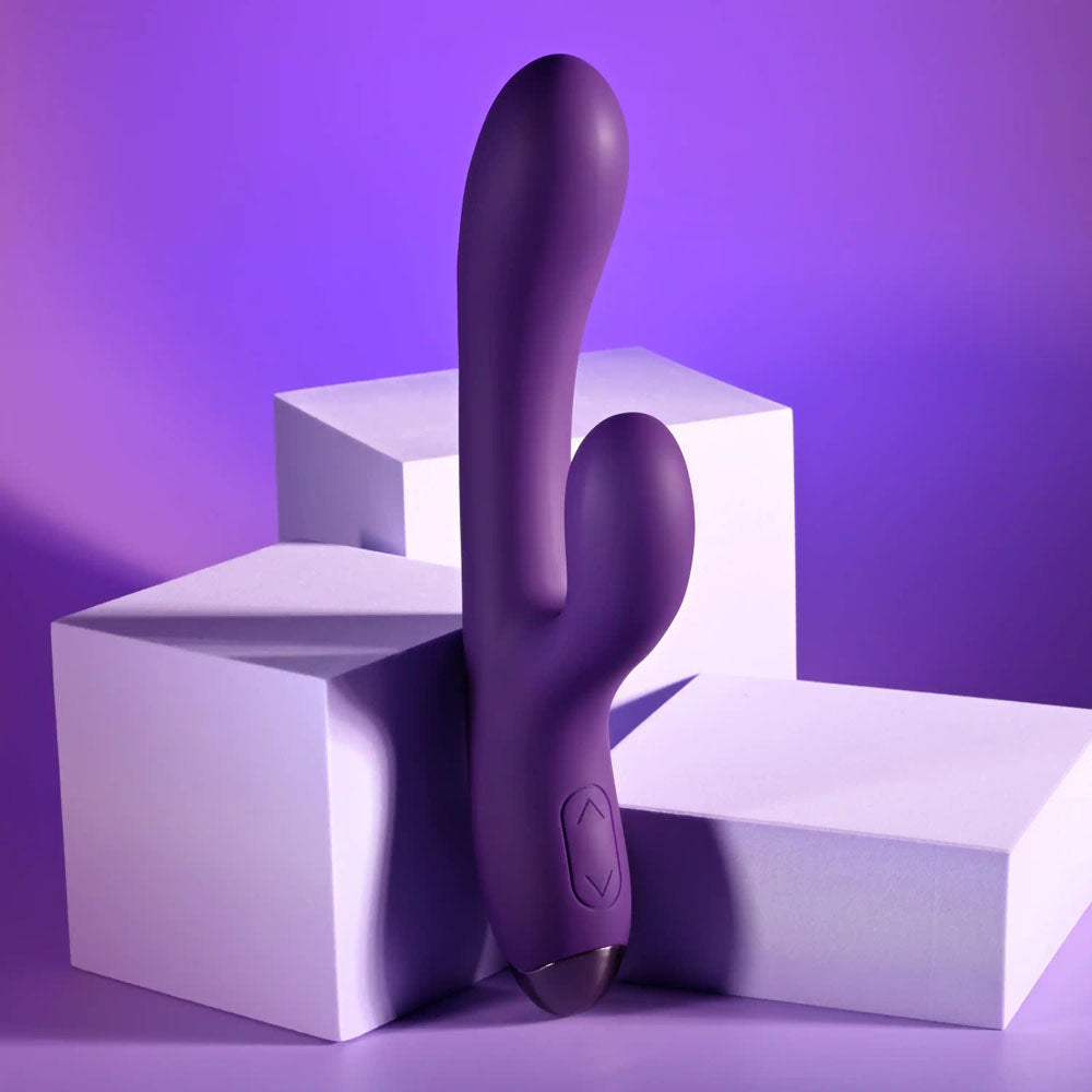 Playboy Pleasure NEW CRUSH - 20.6 cm USB Rechargeable Rabbit Vibrator on a purple background with geometric shapes.