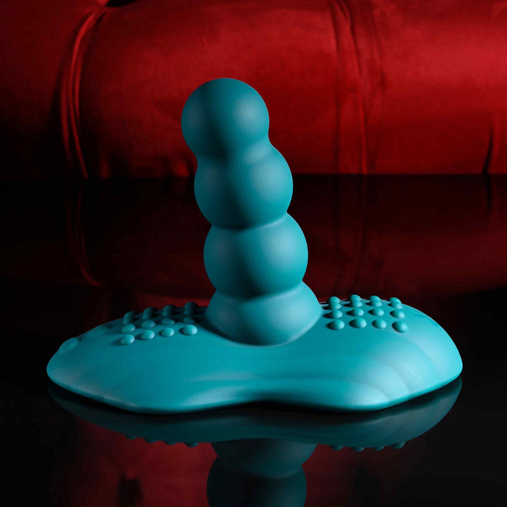 Playboy Pleasure HAVE A SEAT - USB Rechargeable Rideable Vibrator and Grinder Pad with Remote on a glossy surface.