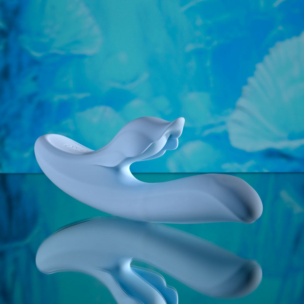 Playboy Pleasure IN BLOOM -  23.5 cm USB Rechargeable Thrusting Tapping & Heating Dual Vibrator on reflective surface.