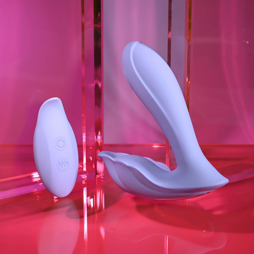 Playboy Pleasure LILAC FANTASY -  13.5 cm USB Rechargeable Tapping Vibrator with Remote displayed on a vibrant pink background.