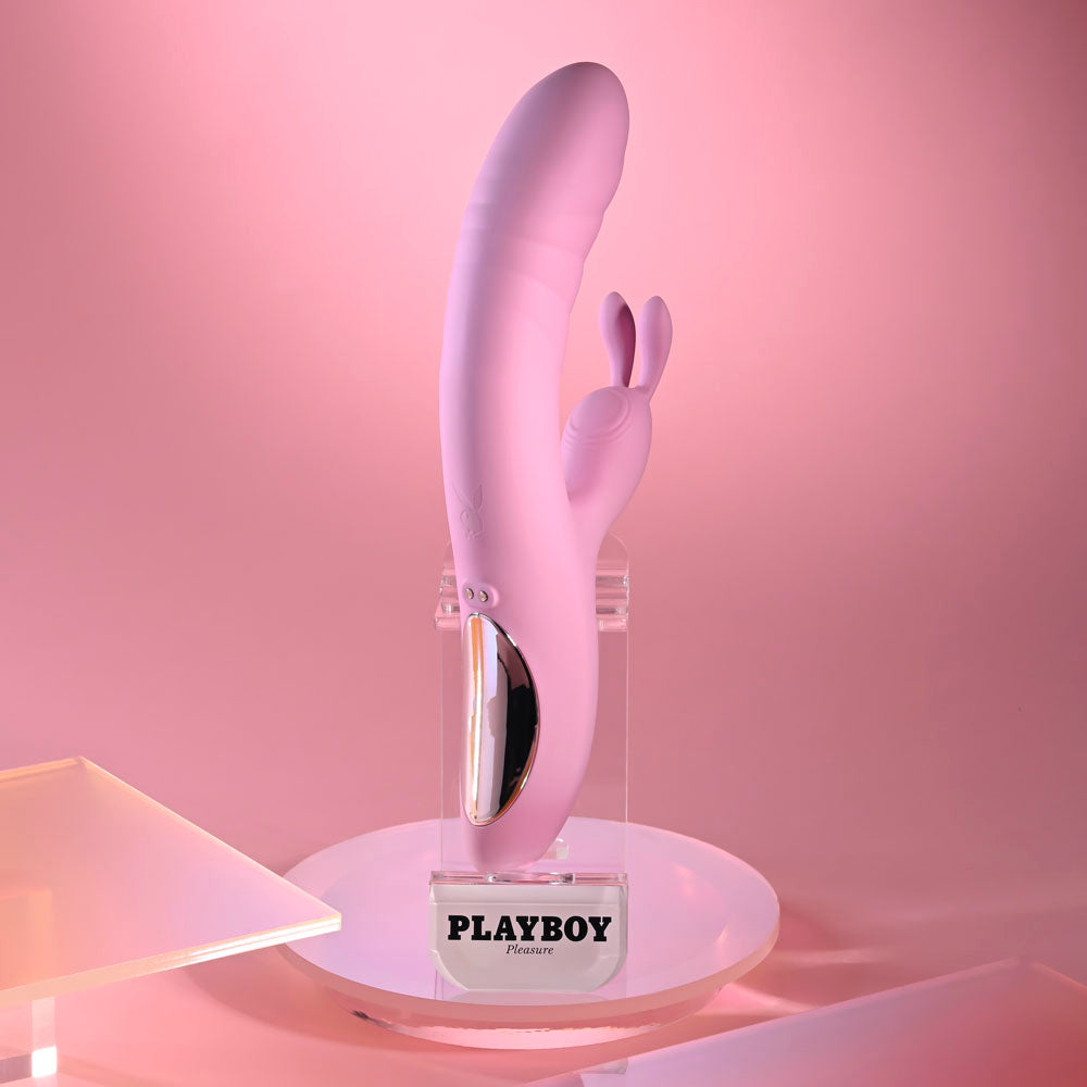 Playboy Pleasure RUB ME RIGHT - 23.2 cm USB Rechargeable Thrusting Rabbit Vibrator on display with soft pink background.