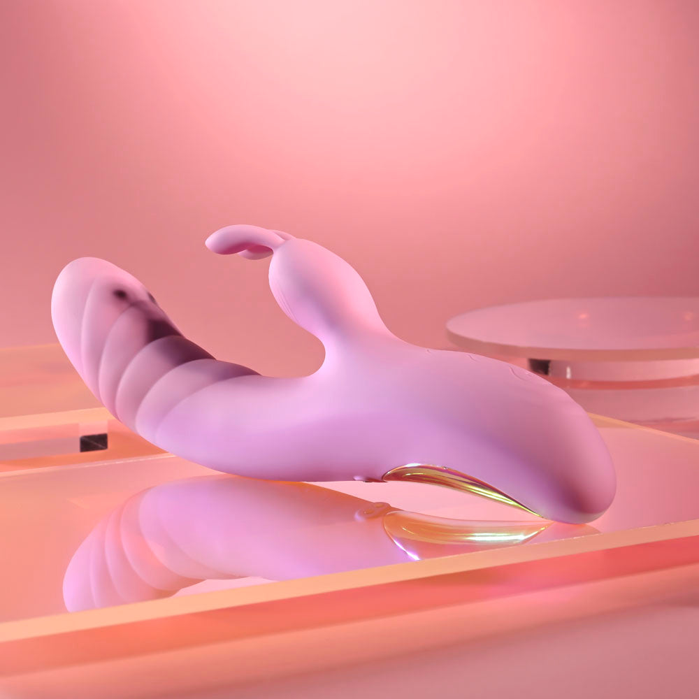 Playboy Pleasure RUB ME RIGHT -  23.2 cm USB Rechargeable Thrusting Rabbit Vibrator on a stylish display.