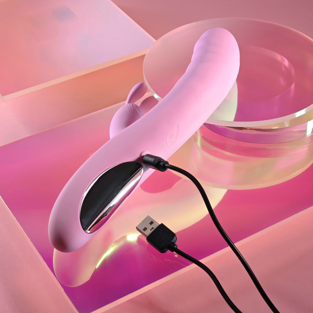 Playboy Pleasure RUB ME RIGHT - 23.2 cm USB Rechargeable Thrusting Rabbit Vibrator on a colorful background.