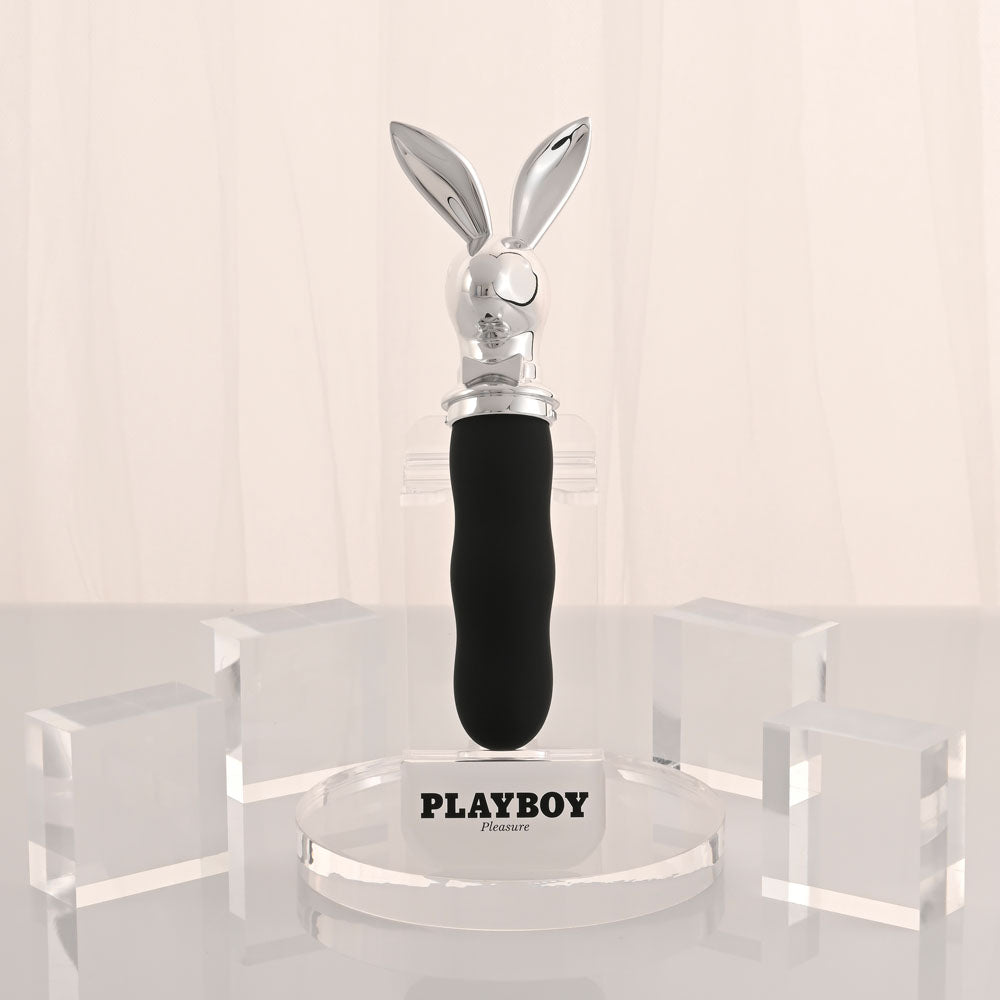 Playboy Pleasure BUNNY ON THE GO - /Chrome 18.6 cm USB-C Rechargeable Vibrator on a display stand.