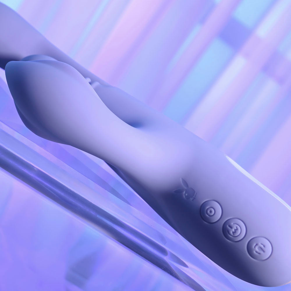 Playboy Pleasure NUBBIN RUBBIN - 24.1 cm USB Rechargeable Thrusting Rabbit Vibrator on a stylish surface.