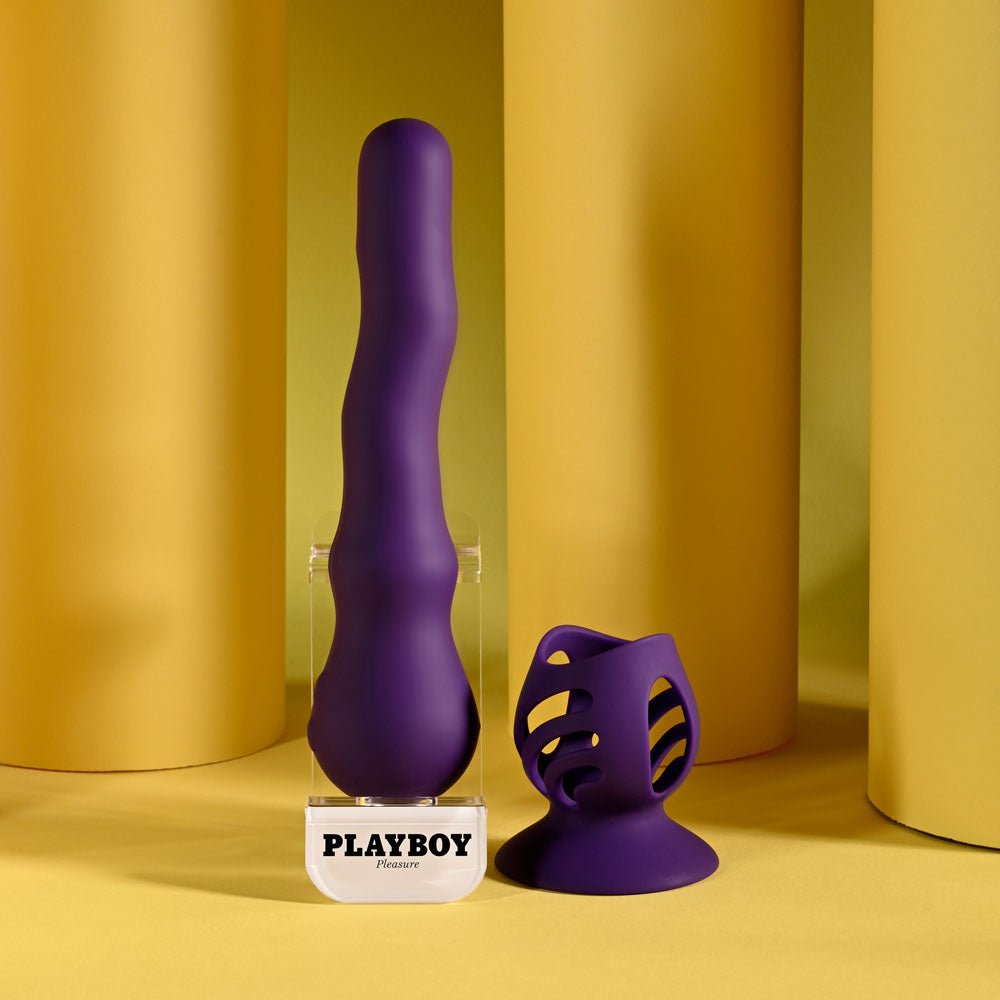 Playboy Pleasure rechargeable wiggling vibrator alongside a textured silicone toy against a vibrant yellow background.