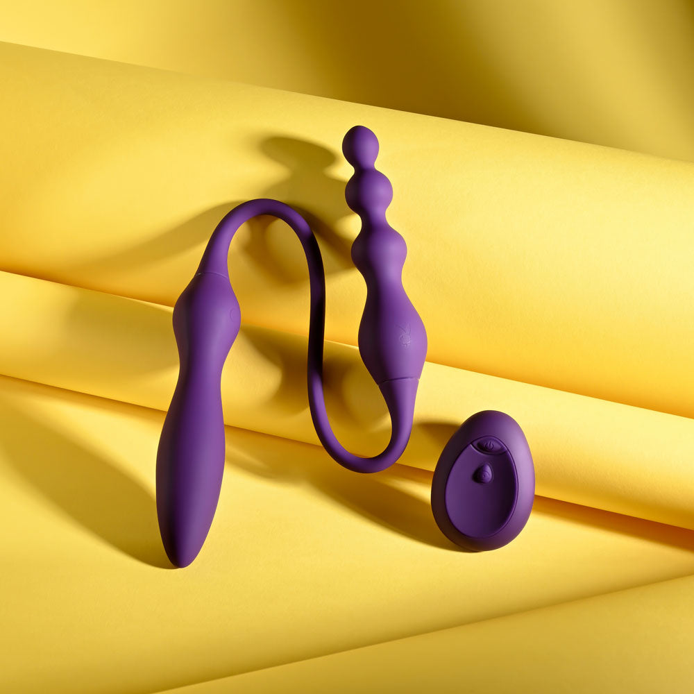 Playboy Pleasure THIS & THAT -  60 cm USB Rechargeable Flexible Dual Ended Vibrator on a vibrant yellow background.