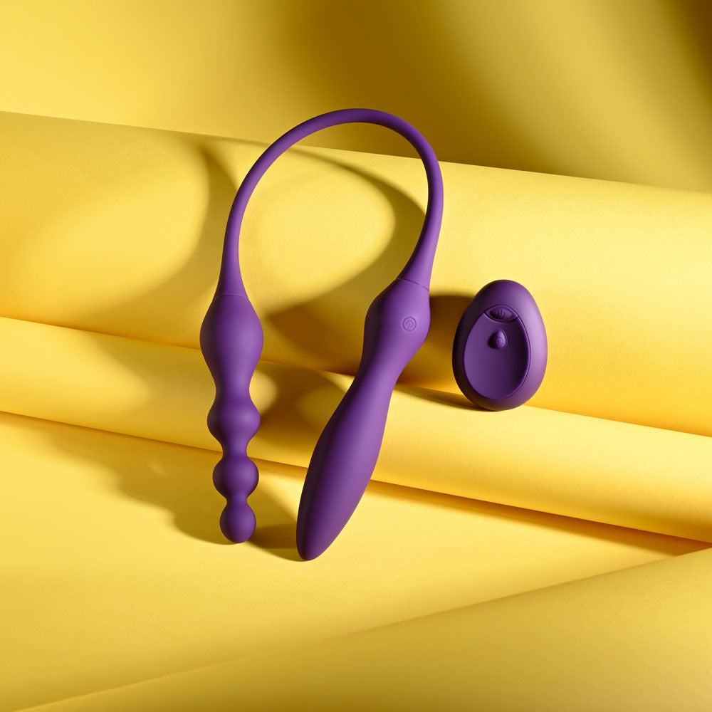 Playboy Pleasure THIS & THAT -  60 cm USB Rechargeable Flexible Dual Ended Vibrator on yellow backdrop.