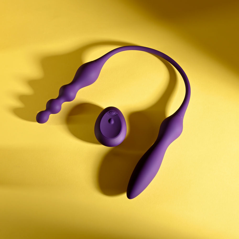 Playboy Pleasure THIS & THAT -  60 cm USB Rechargeable Flexible Dual Ended Vibrator on a yellow background.