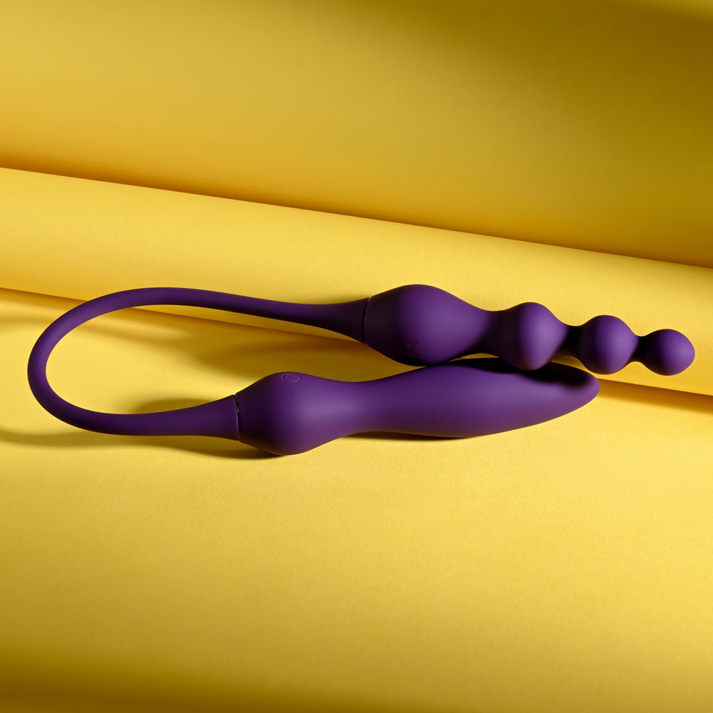 Playboy Pleasure THIS & THAT - 60 cm USB Rechargeable Flexible Dual Ended Vibrator displayed on a yellow background.