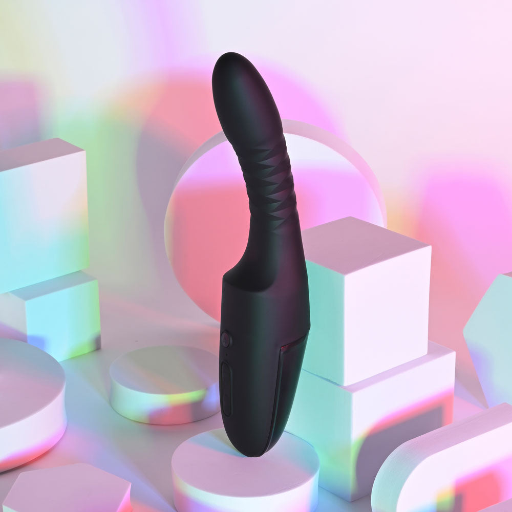 Playboy Pleasure OVERDRIVE 28.2 cm USB rechargeable thrusting vibrator displayed on colorful geometric background.