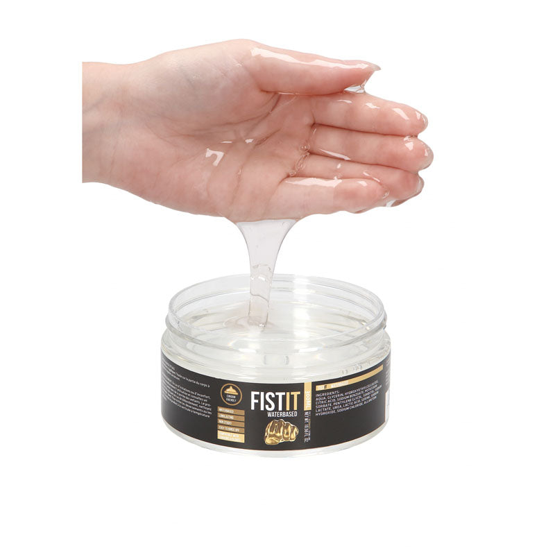 PHARMQUESTS Fist-It Water Based - 300ml - Water Based Lubricant - 300 ml Tub shown in hand, demonstrating its gel-like texture.