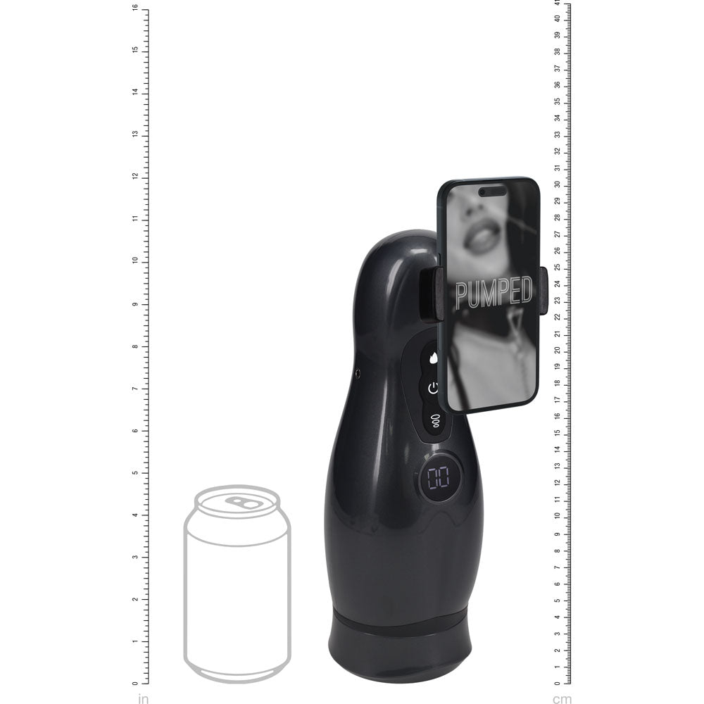 PUMPED Virtuo - Gunmetal - Gunmetal Grey/Clear USB Rechargeable Sucking And Vibrating Auto Masturbator next to a can for size reference.