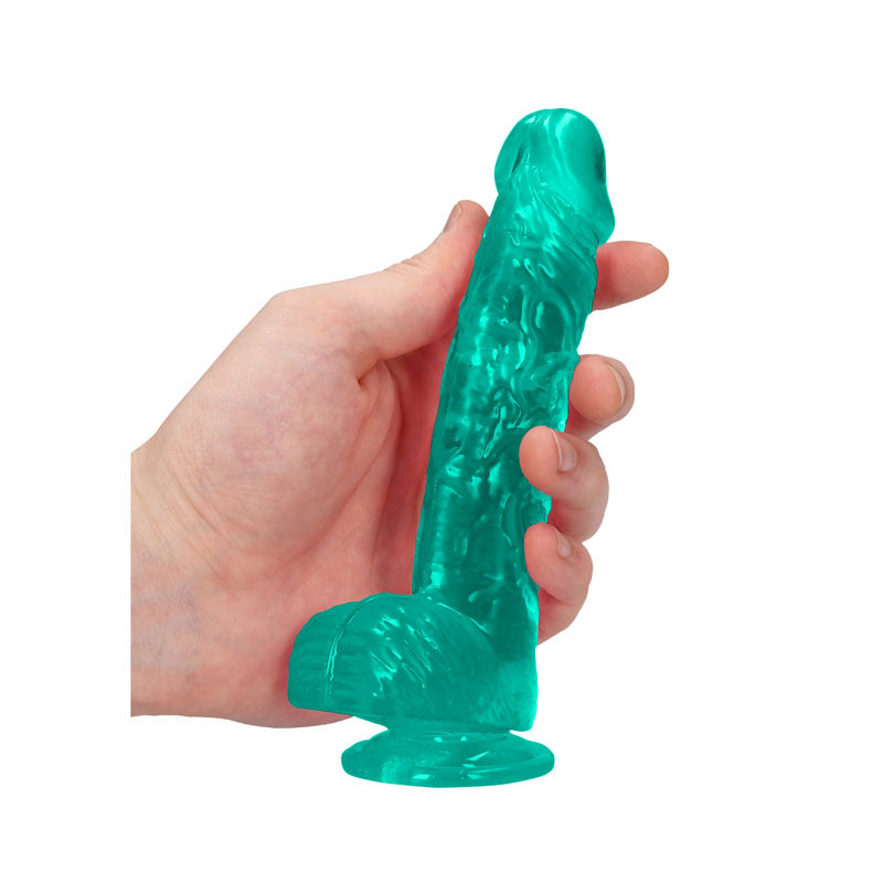 Hand holding REALROCK 6'' realistic dildo with balls in turquoise color, showcasing its lifelike design and sturdy suction cup.