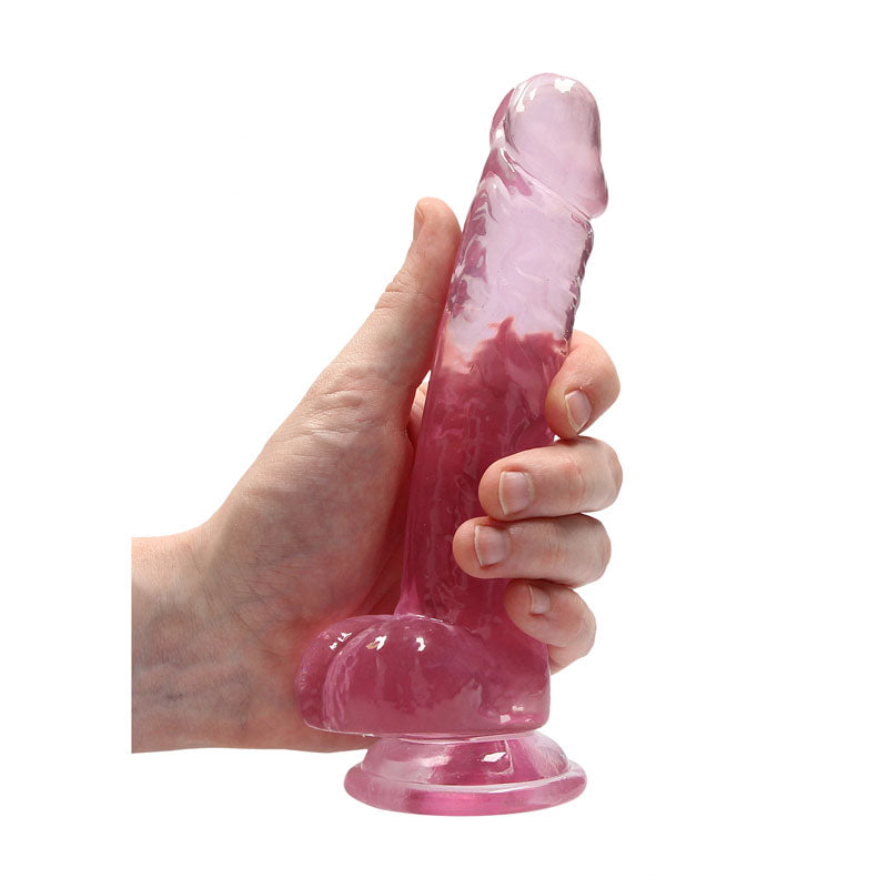 REALROCK 7'' Realistic Dildo With Balls -  17.8 cm Dong held in hand, showcasing its lifelike design and sturdy suction cup.