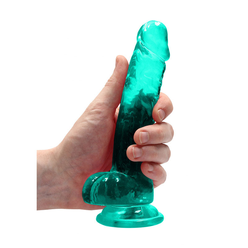 REALROCK 7'' realistic dildo with suction cup in turquoise held by hand, showcasing lifelike design and sturdy suction base.