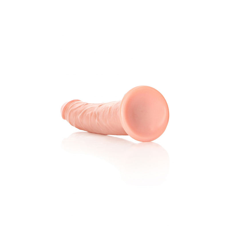 REALROCK Realistic Slim Dildo with Suction Cup - 18cm -  18 cm (7'') Dong on a reflective surface, showcasing its natural look.