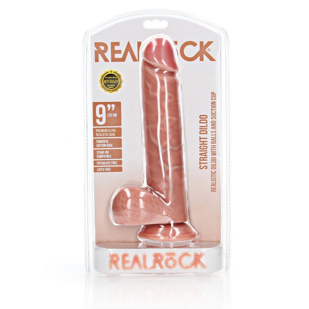 REALROCK Straight Realistic Dildo with Balls - 23 cm - 23 cm (9'') Dong in packaging for intimate essentials and adult entertainment.
