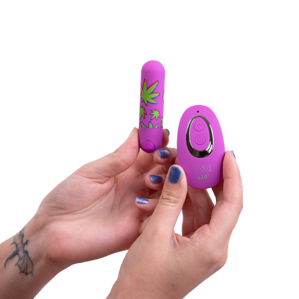 Maia JESSI 420 Remote -  7.6 cm USB Rechargeable Bullet with Wireless Remote held in hands.