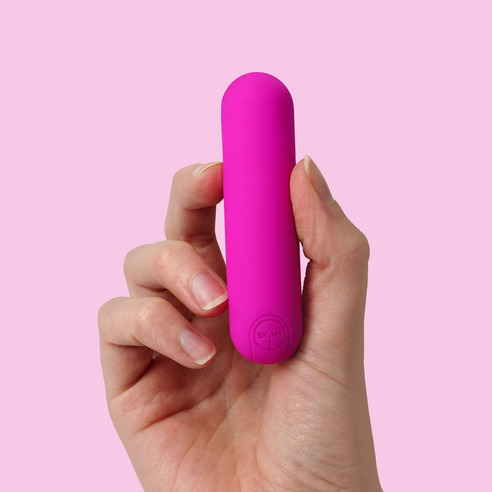 Skins Super Excite Rechargeable Bullet - USB Rechargeable Bullet in hand, showcasing its compact and discreet design for intimate essentials.