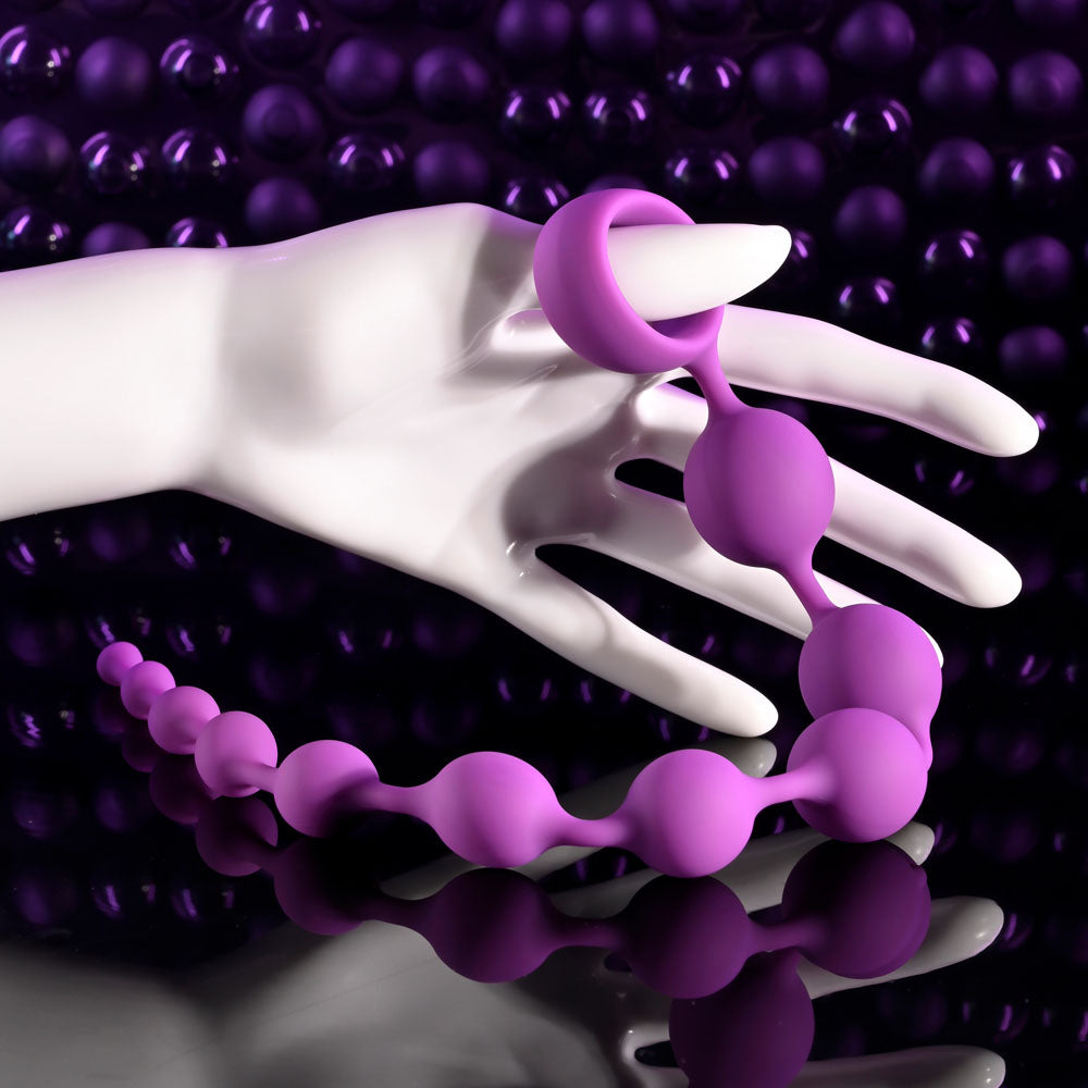 Selopa BEADED ADVENTURE -  35.5 cm Anal Beads displayed in a hand, showcasing flexible silicone design and vibrant color.
