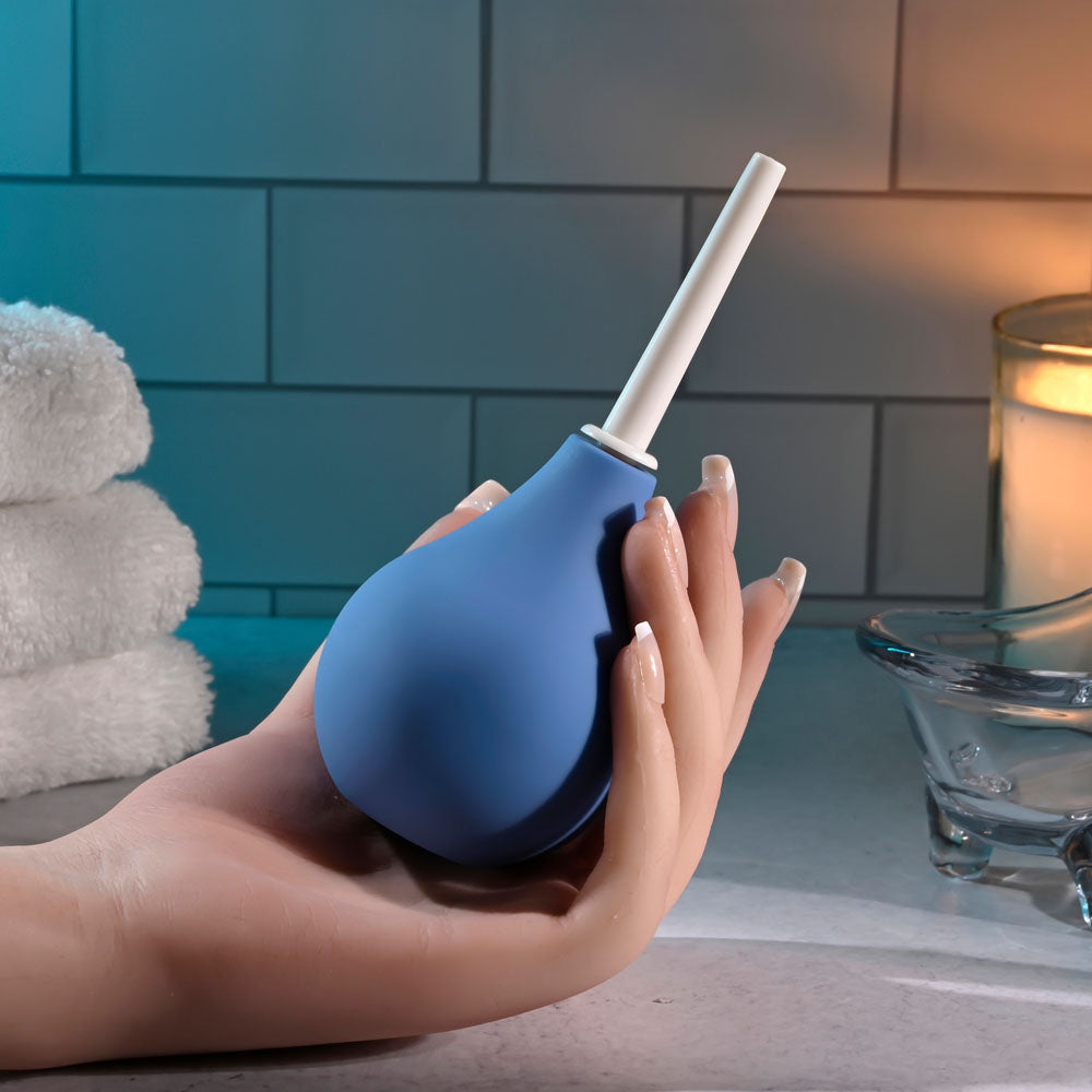 Selopa SQUEAKY CLEAN -  Unisex Douche held in a hand, designed for gentle anal cleansing with a sleek blue finish.