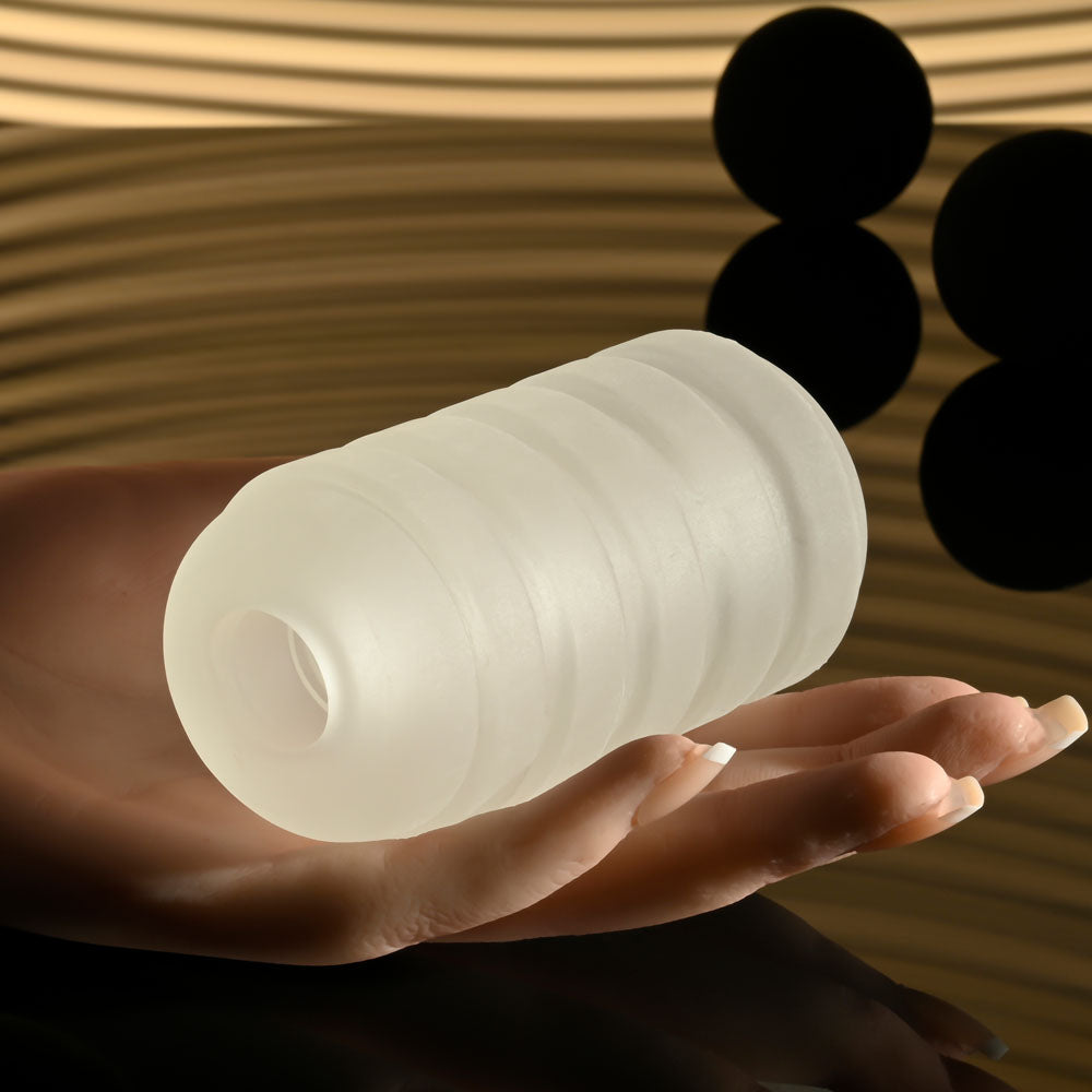 Selopa RING ME UP -  Stroker held in a hand, showcasing its squishy and soft texture with deep grooves.