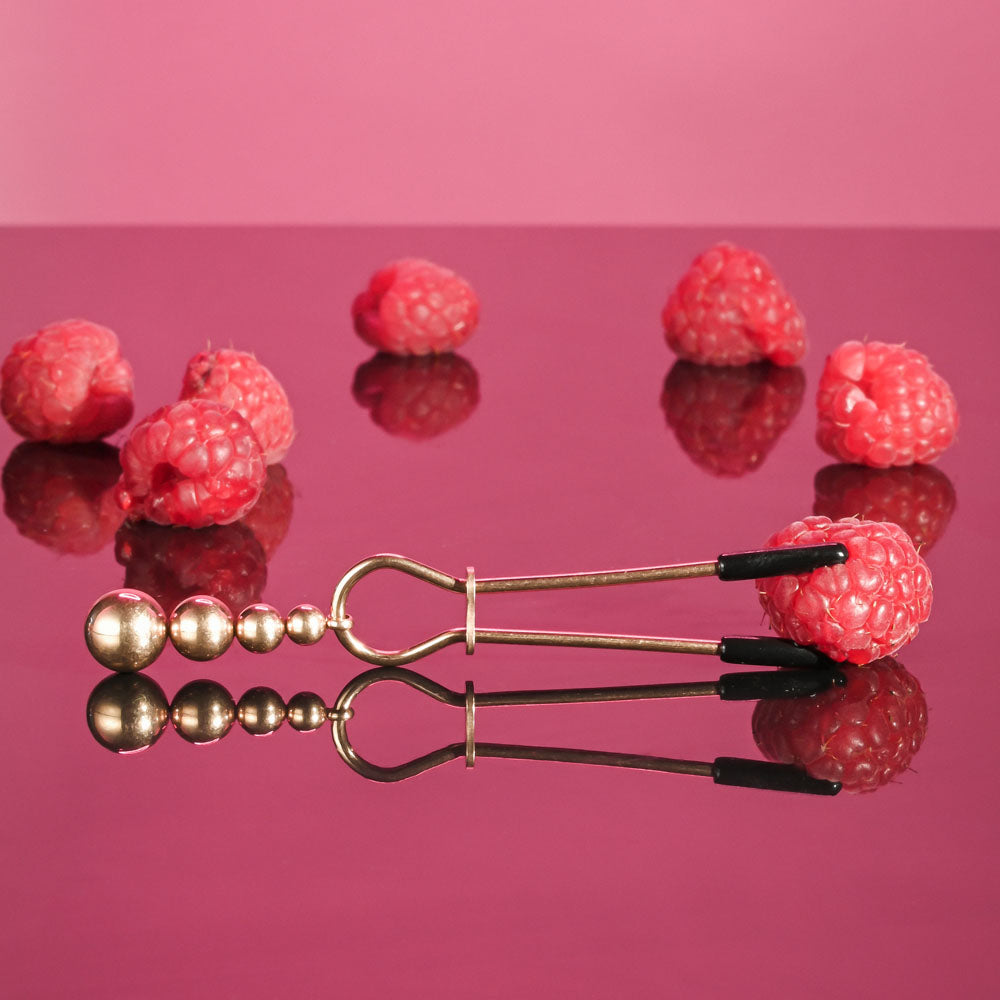 Selopa BEADED NIPPLE CLAMPS -  -  Nipple Clamps - Set of 2 with raspberry backdrop, providing visual appeal and enjoyment.