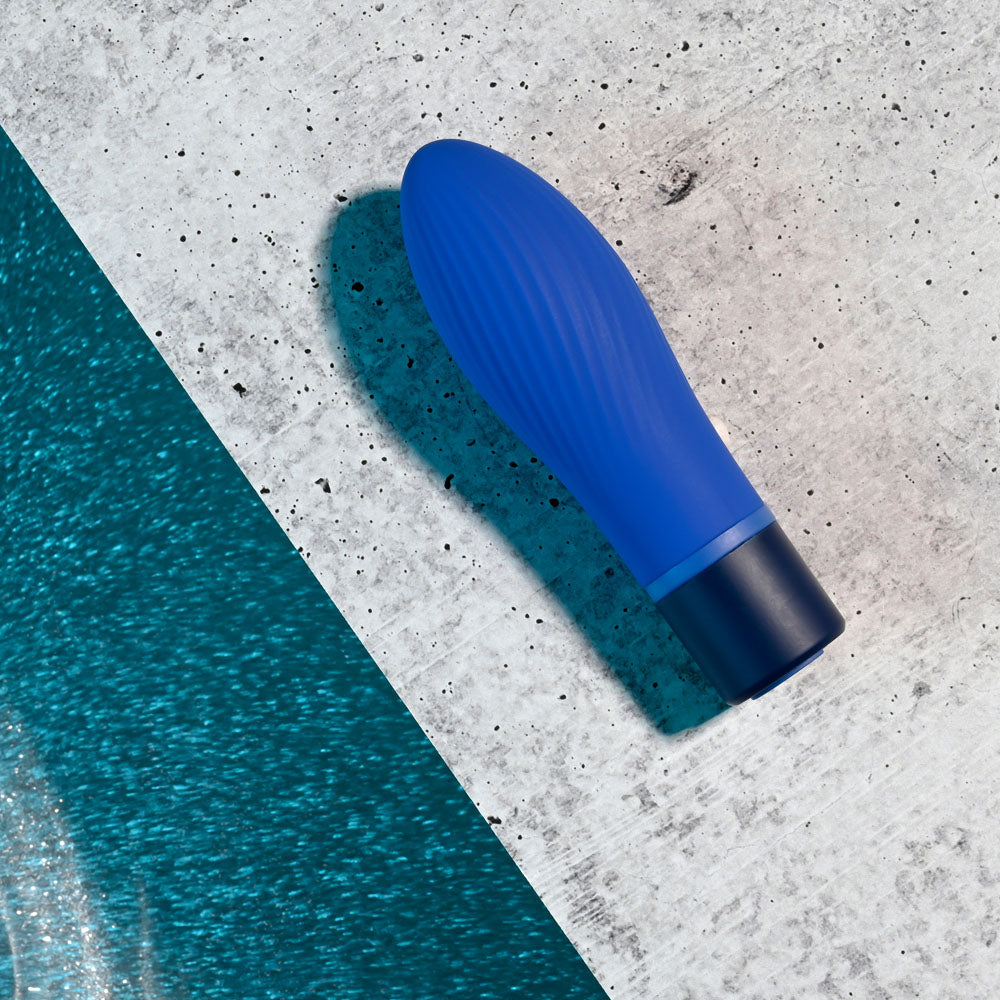 Selopa COBALT CUTIE - vibrant blue vibrating toy on concrete surface, perfect for intimate essentials for her.