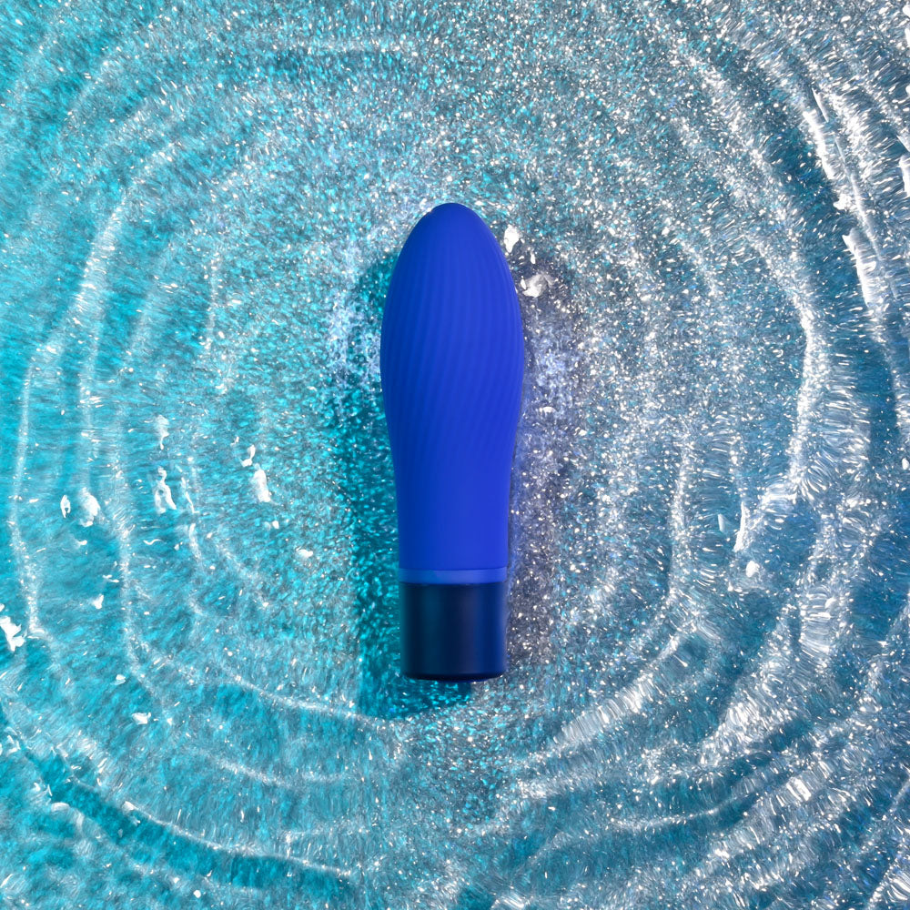 Selopa COBALT CUTIE - vibrant blue vibrating toy against sparkly water background, perfect for intimate essentials for her.