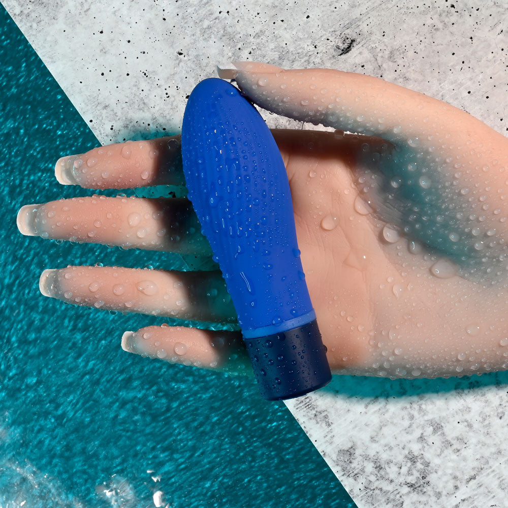 Selopa COBALT CUTIE - blue vibrating toy resting on a hand, showcasing its design and waterproof features.