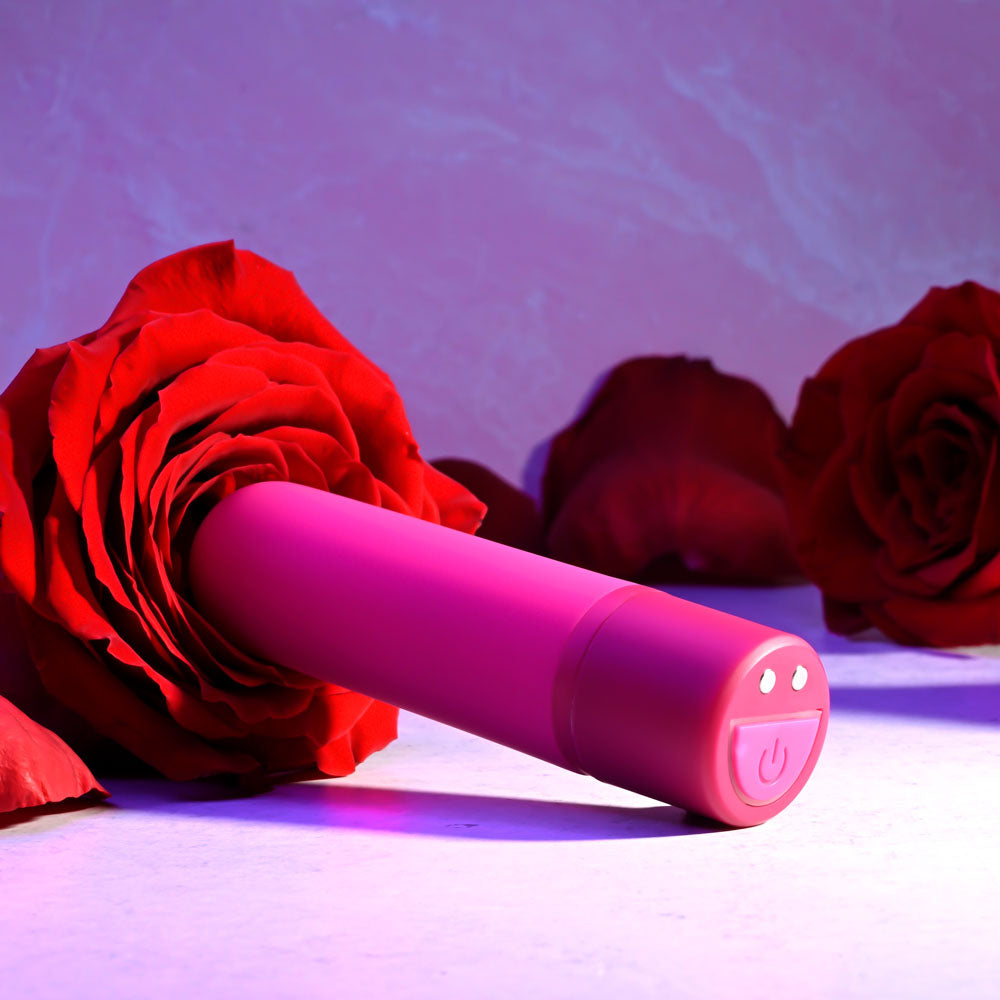Selopa TINY TEMPTATION -  9.2 cm USB Rechargeable Bullet nestled among red roses, emphasizing intimate essentials for her.