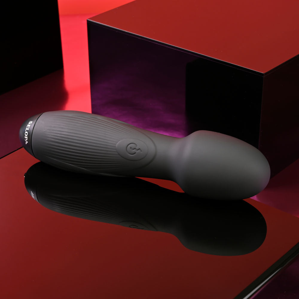 Selopa POWER TRIP -  18.8 cm USB Rechargeable Massage Wand resting on a reflective surface with a sleek, stylish design.