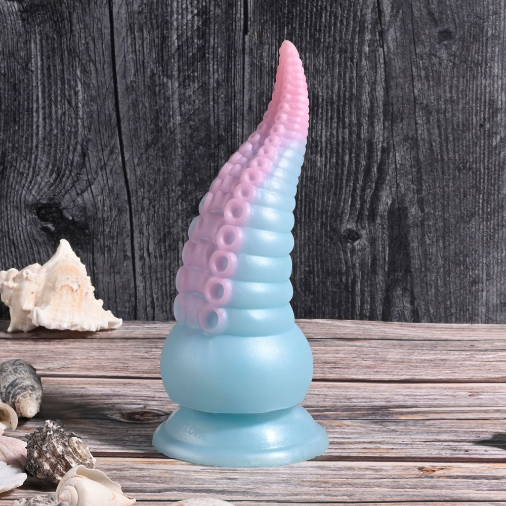 Selopa STUCK ON YOU - Blue/Pink 19 cm USB Rechargeable Vibrating Tentacle Fantasy Dildo on a wooden surface.