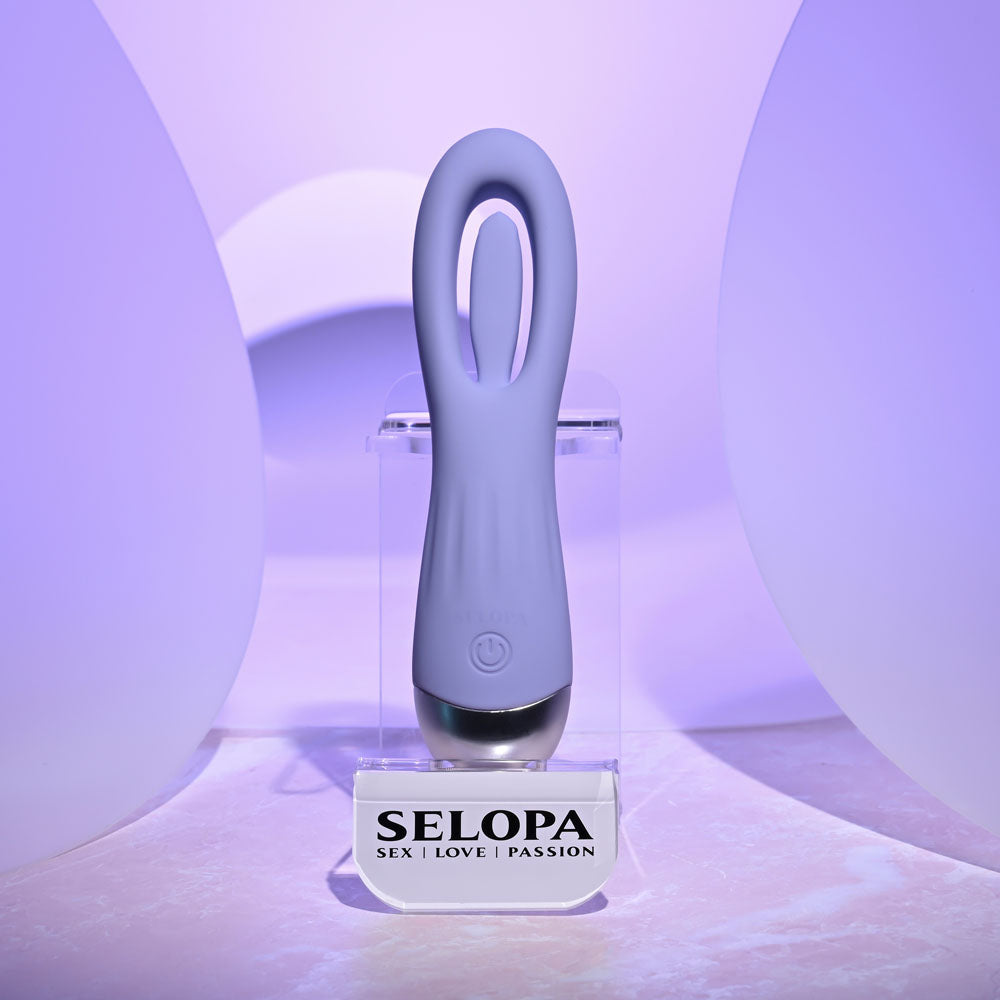 Selopa IN A FLAP -  15 cm USB Rechargeable Flicking Stimulator displayed on a stand in soft lighting.