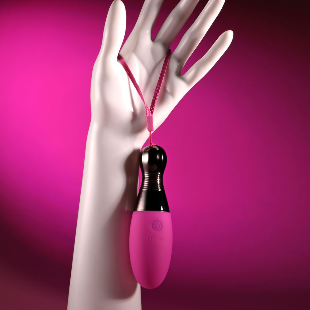 Selopa COMPANION -  11.9 cm USB Rechargeable Vibrating Egg held by a hand against a pink background.