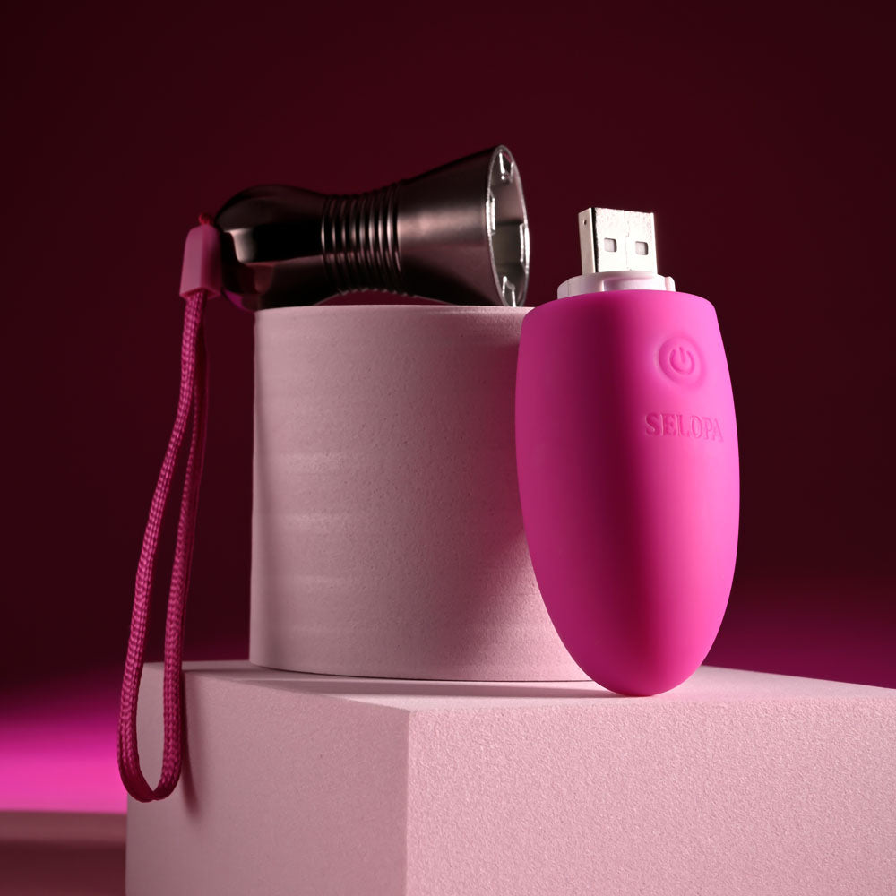 Selopa COMPANION -  11.9 cm USB Rechargeable Vibrating Egg on a pink background with a USB connection and retrieval cord.