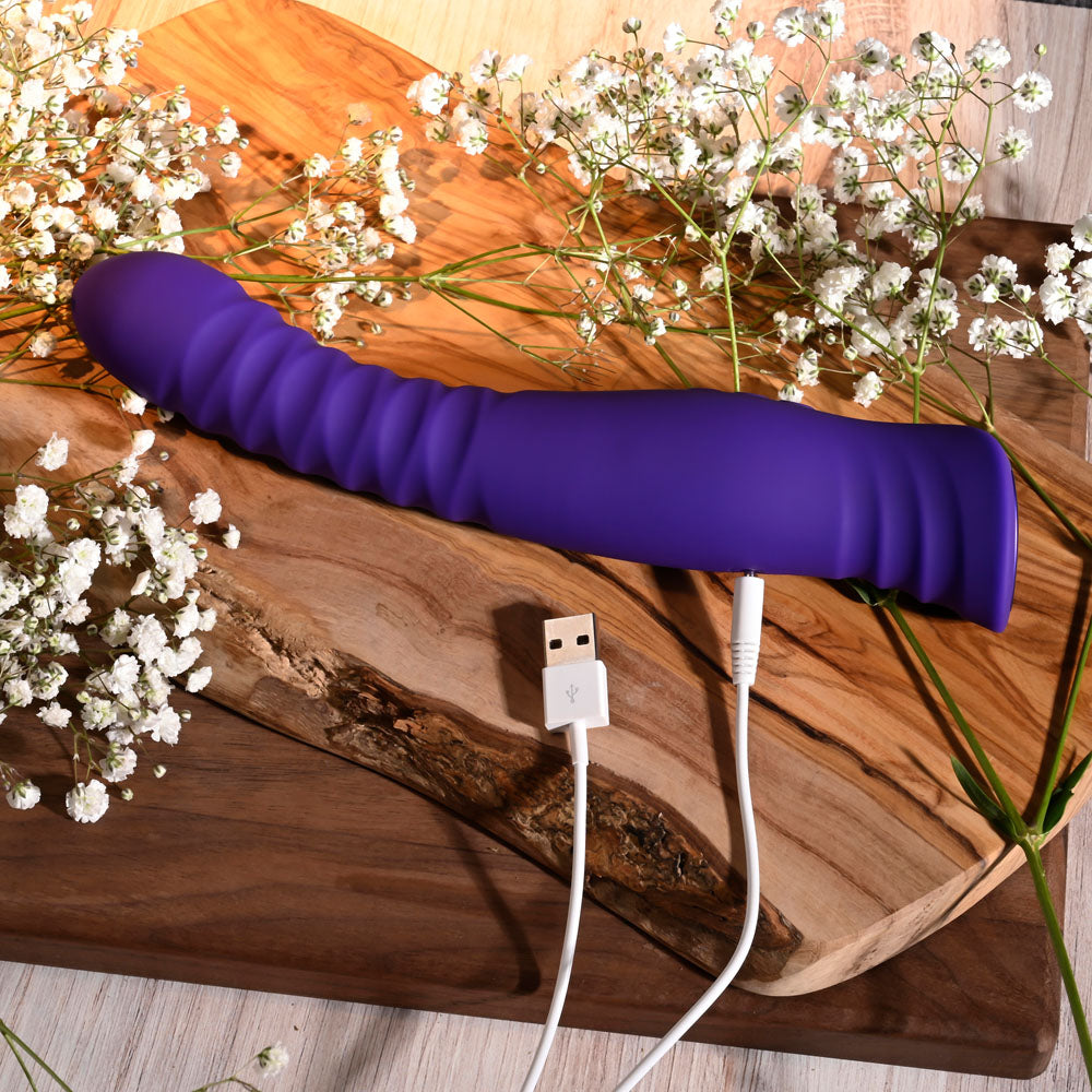 Selopa TRIXXXIE -  22.2 cm USB Rechargeable Vibrator on a wooden surface with flowers and USB cable.