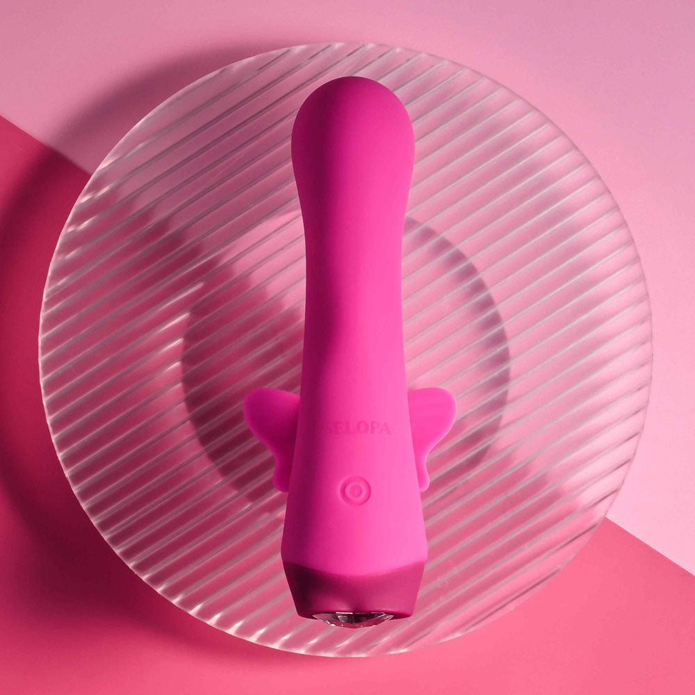 Selopa BUTTERFLY LOVE -  13.8 cm USB Rechargeable Butterfly Vibrator on a textured plate, showcasing its vibrant pink design.